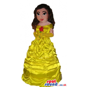 Princess with long brown hair wearing a long yellow dress -