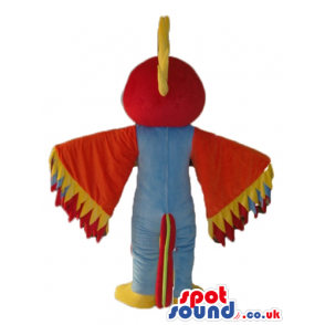 Purple bird with big red head with yellow detail on top, with