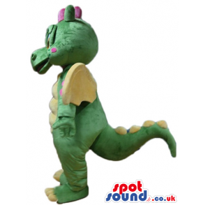 Green crocodile with yellow belly and pink plaques along the